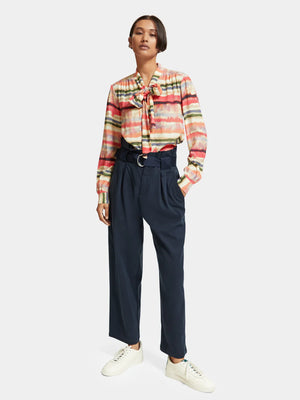 woman wearing Psychedelic Shirt Tie Neck and navy pants
