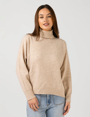 woman wearing Iris Jumper - Oat and light blue denim pants
