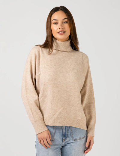 woman wearing Iris Jumper - Oat and light blue denim pants