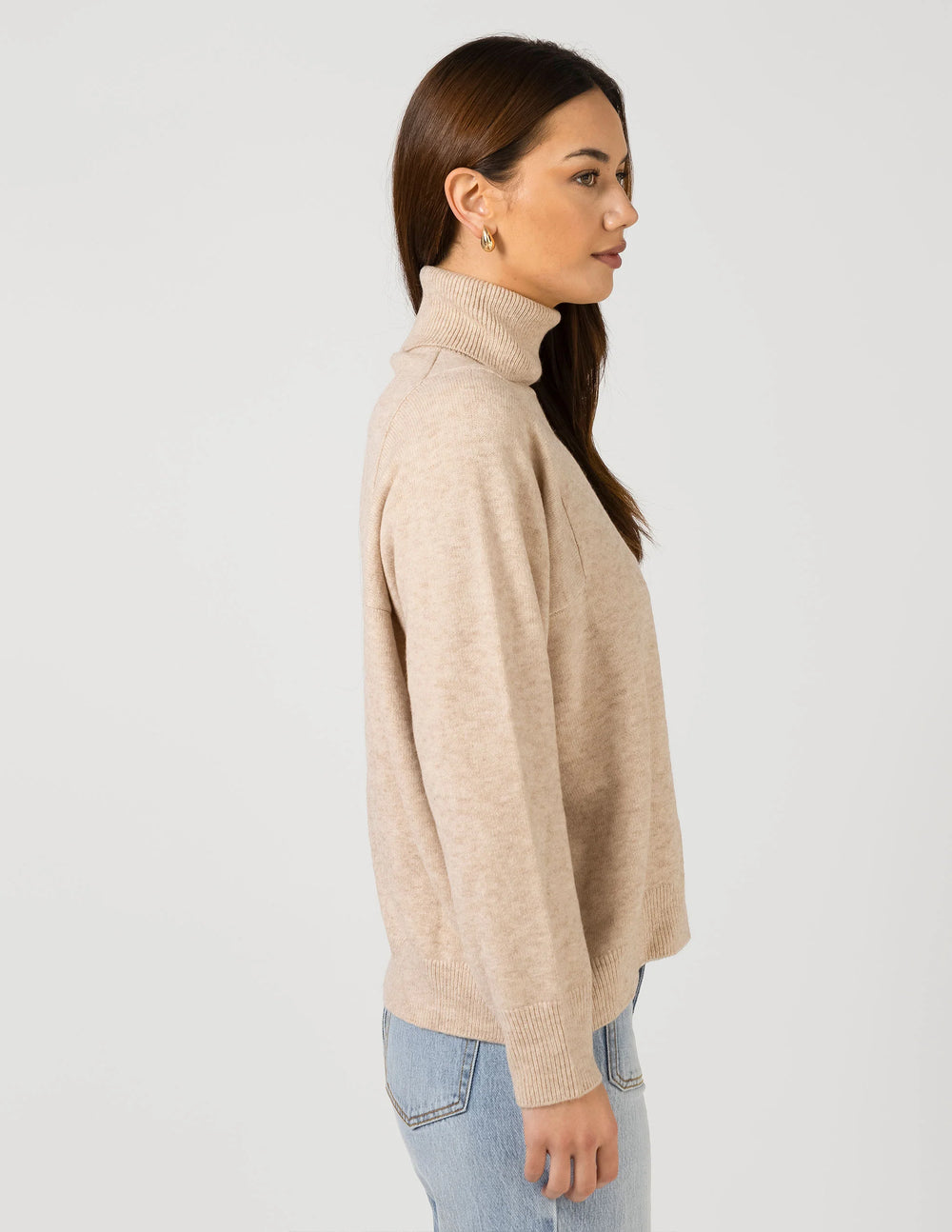 woman wearing Iris Jumper - Oat and light blue denim pants