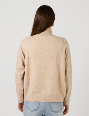 woman facing the back wearing Iris Jumper - Oat and light blue denim pants