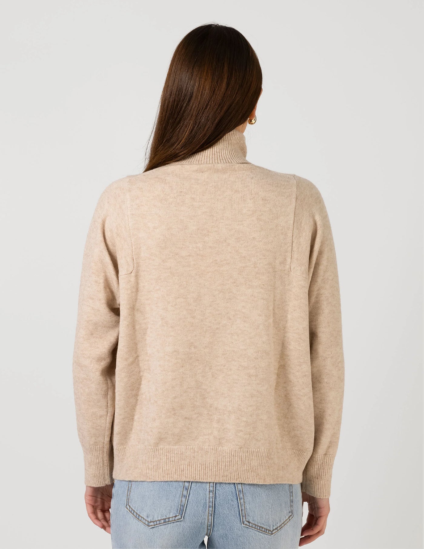 woman facing the back wearing Iris Jumper - Oat and light blue denim pants