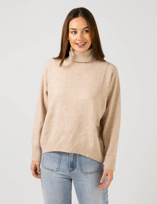 woman wearing Iris Jumper - Oat and light blue denim pants