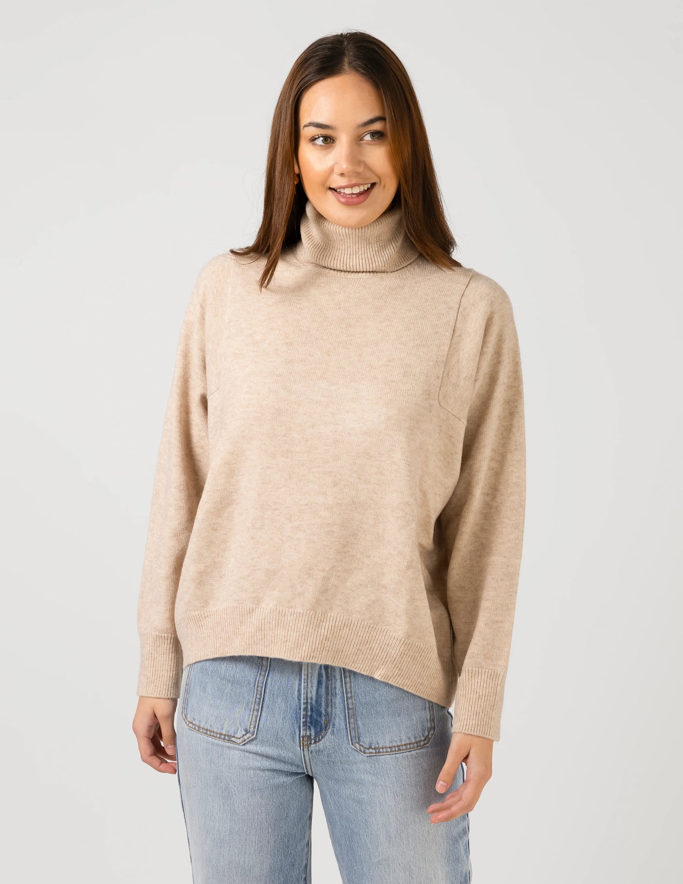 woman wearing Iris Jumper - Oat and light blue denim pants