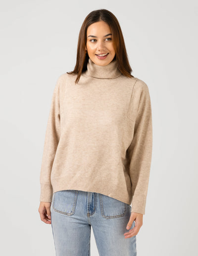 woman wearing Iris Jumper - Oat and light blue denim pants