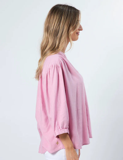 woman facing the side wearing Tammy Blouse - Marshmallow and white pants