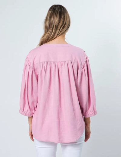 woman facing the back wearing Tammy Blouse - Marshmallow and white pants