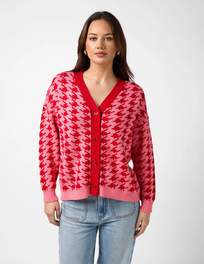 woman wearing Xanthe Houndstooth Cardigan - Red & Candy and light blue denim pants